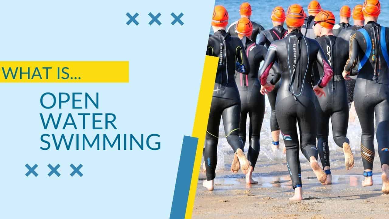 Thumbnail for "what is open water swimming" picture of a group of people in wet suits getting in the water.